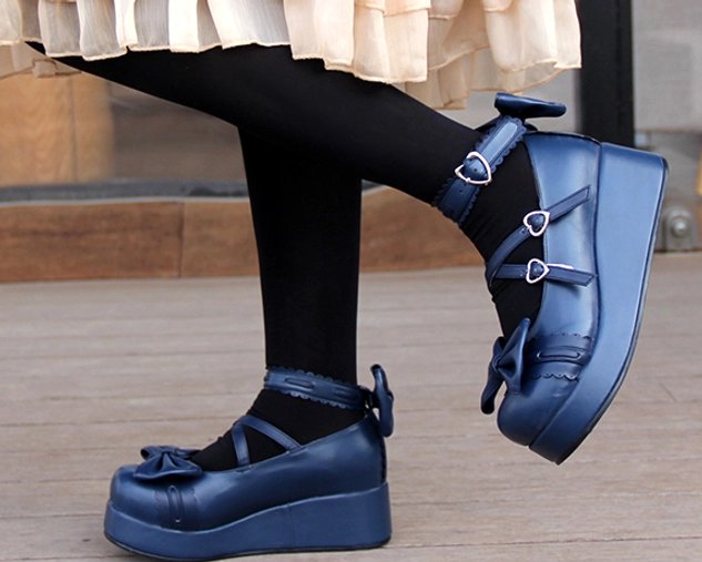 Navy blue sweet Lolita platform Mary Jane shoes worn on feet lower side angle view with frilly skirt and black socks street style coordination