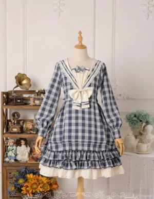 Navy blue tartan sailor lolita one-piece dress with cream sailor collar bow and ruffles, long puff sleeves, layered skirt hem with white petticoat, mannequin display vintage studio