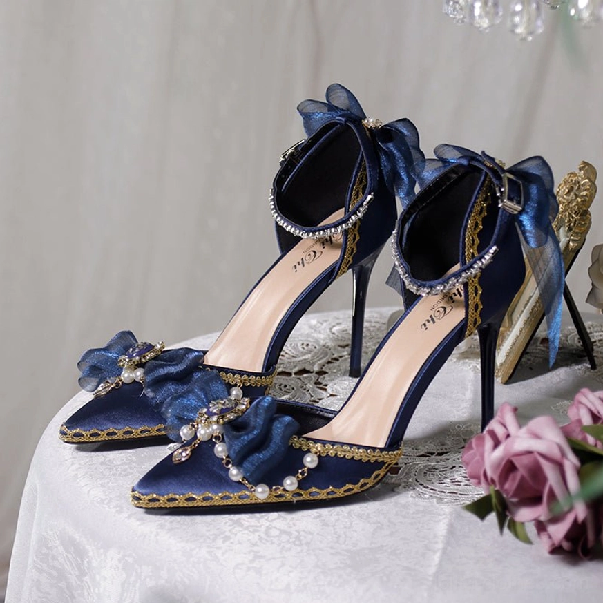 Navy blue pointed toe lolita wedding heels ankle strap sheer ribbon bow gold edging pearl gem decorations three-quarter view