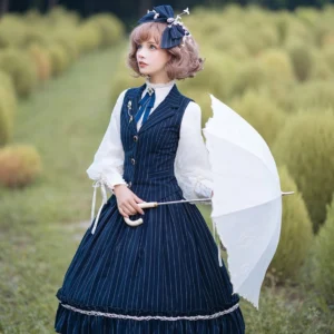Navy pinstripe wool lolita vest with 3D tailored cut worn outdoors by female model in grassland, styled with white lace parasol and matching blouse in classic preppy lolita fashion