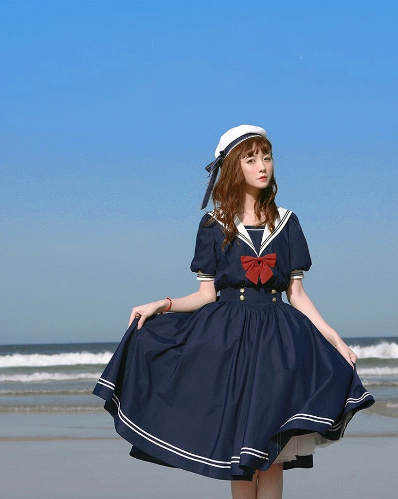 Navy blue sailor lolita OP dress medium closeup front upper body view red chest bow white collar golden buttons puff sleeves indoor