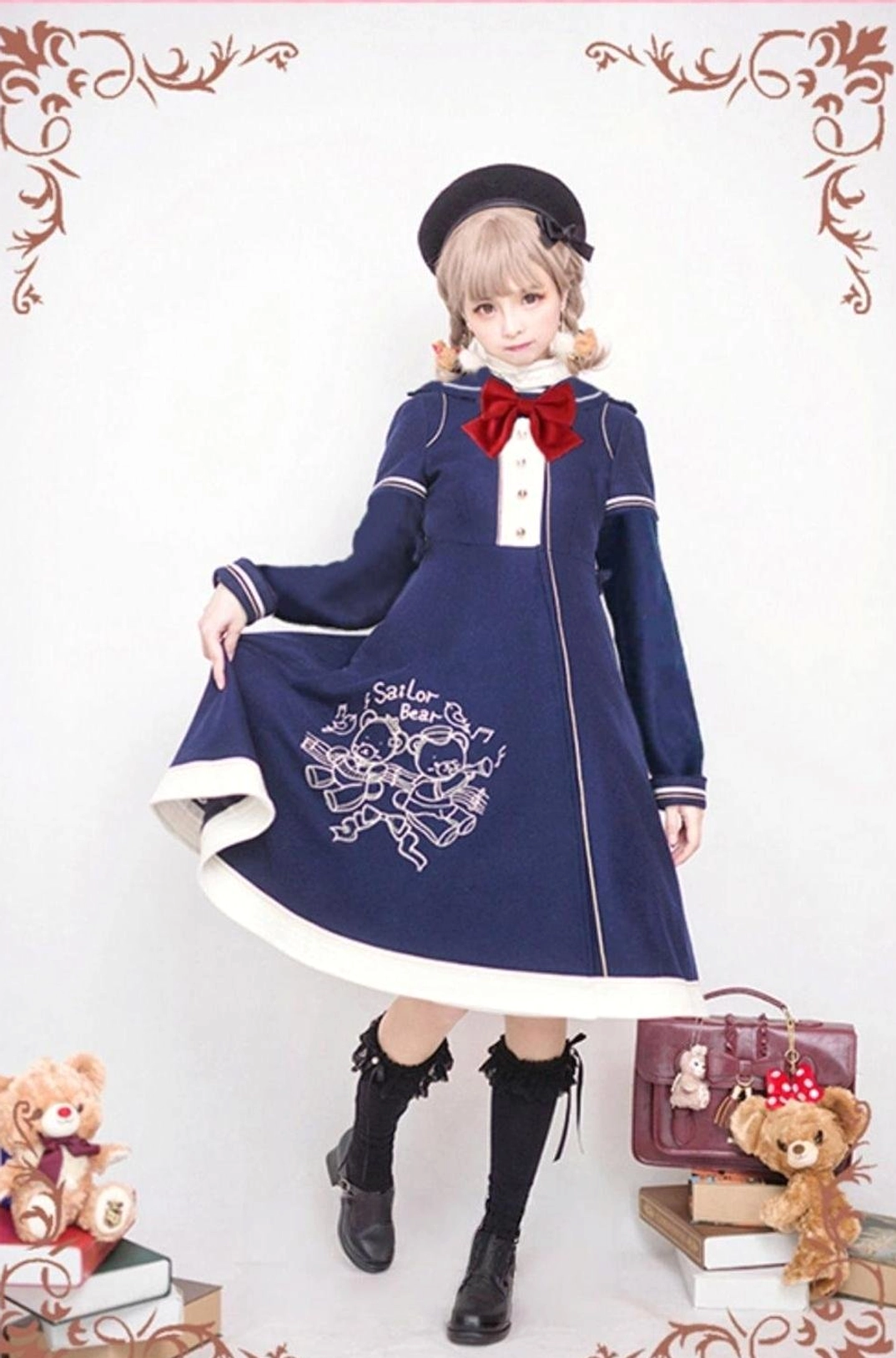Navy blue sailor lolita overcoat with red bow tie collar, white skirt hem trim, bear embroidery on A-line skirt, three-quarter frontal view with lifted skirt hem
