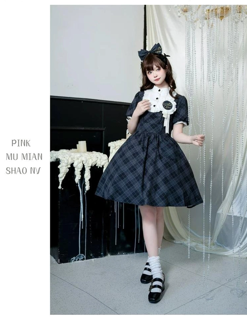 Navy blue dark plaid showa retro lolita OP dress full-body three-quarter front view with matching navy bow ruffled collar brooch classic A-line silhouette with brand candle decor