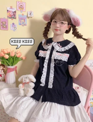 Navy blue cotton jacquard sweet lolita blouse featuring Peter Pan collar with white lace trim, puff sleeves, and ruffled hem, modeled with twin braids and white ruffled skirt in cartoon-themed scene