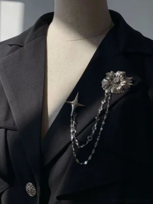 Silver Ouji Lolita metal chain brooch with floral crystal centerpiece, draped rhinestone chains, and star charm on black blazer