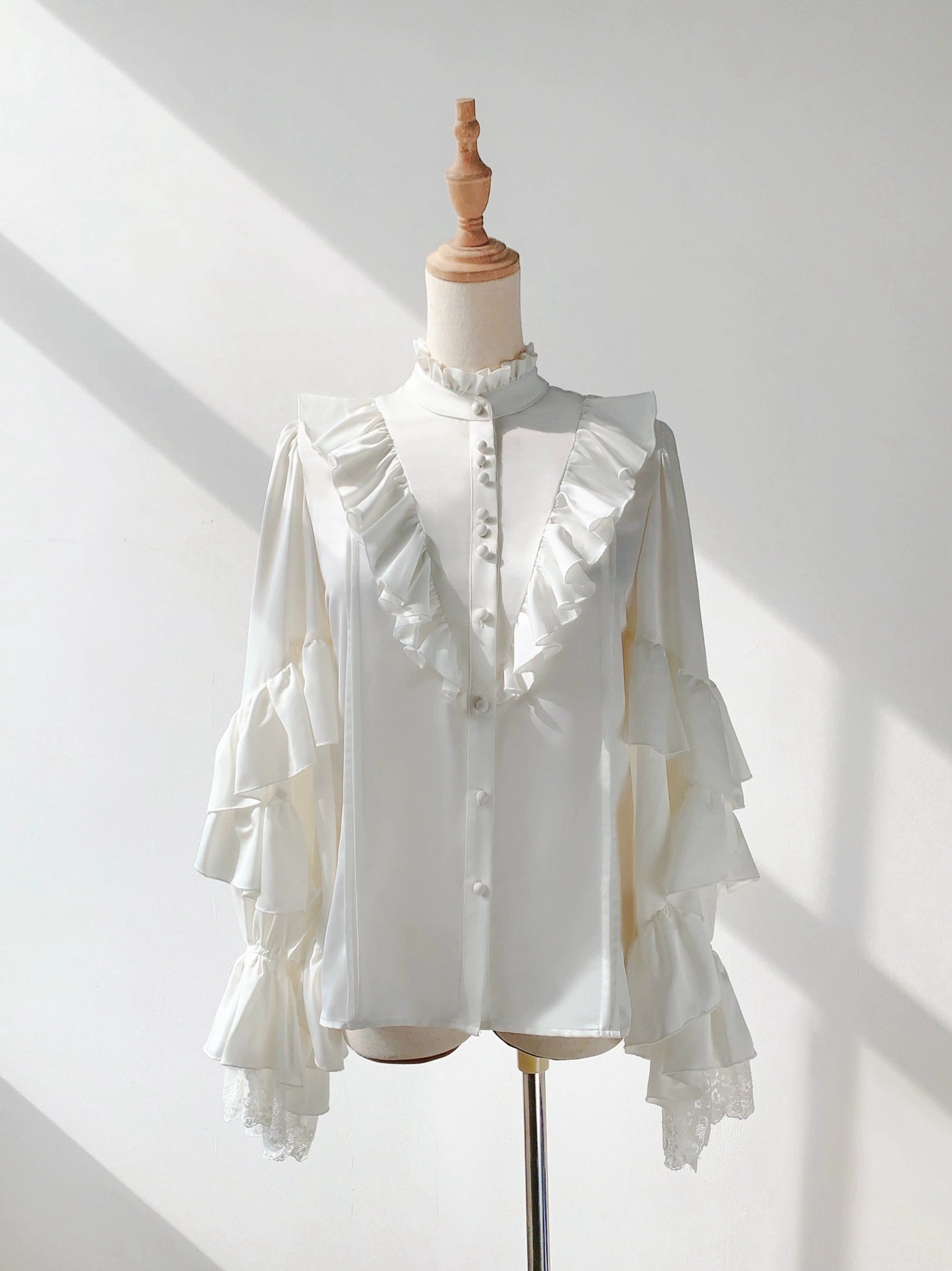 White ruffled stand-collar ouji lolita blouse front flat display dress form soft satin layered flared long sleeves button placket details