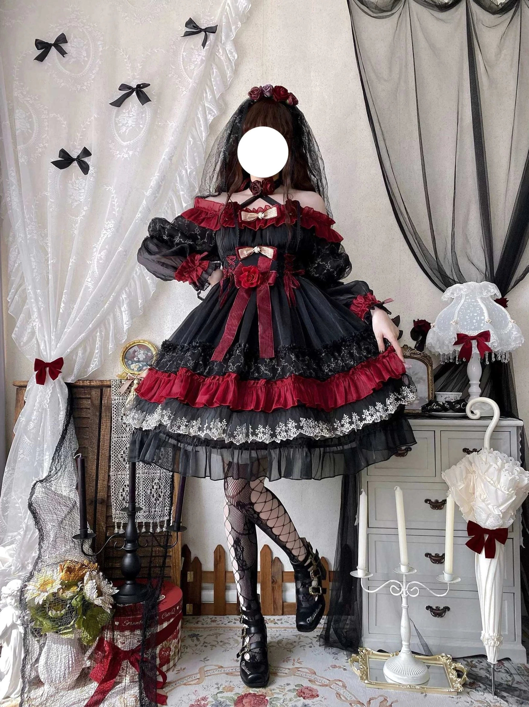 Close-up detail of black and red gothic lolita OP dress lace sleeves, front bodice construction, and sheer overlay with silver lace accents and ribbon details