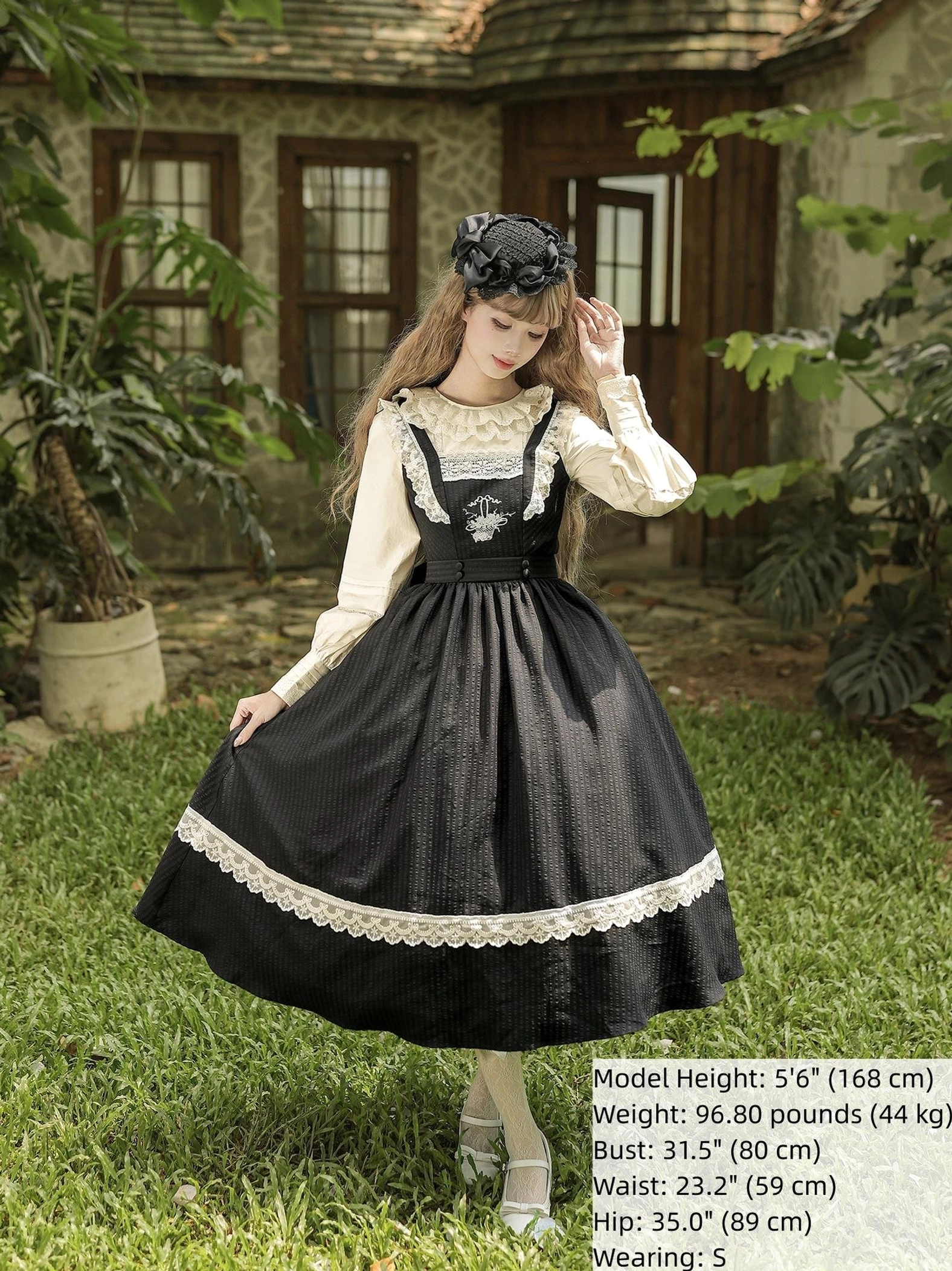 Model wearing black lolita JSK with white ruffled lace collar blouse and embroidered bust panel, full-body front shot on green lawn showing coordinate styling options