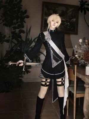 Oathbound noir ouji lolita military coat set front full-body view with asymmetric silver embroidered black coat, high-low hemline, thigh harness shorts, androgynous blonde model holding medieval sword in vintage fireplace dining room setting