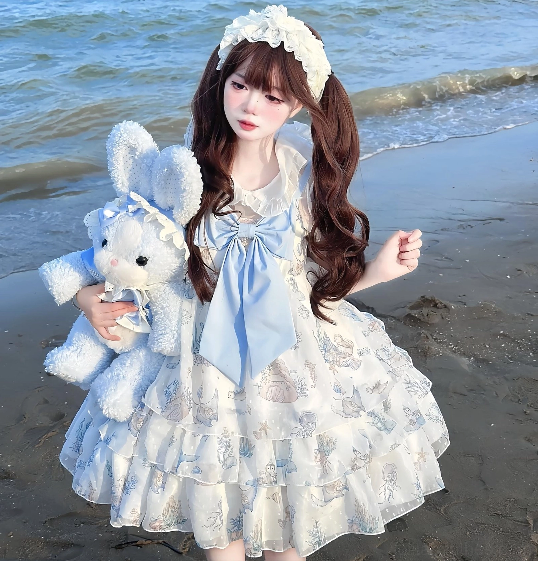 Ocean Sweetheart white sweet lolita jsk dress with light blue whale jellyfish print tiered ruffled skirt front view beach setting