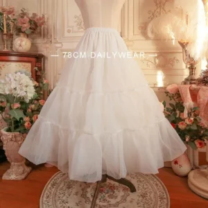 Off-white A-line lolita dailywear petticoat front view on dress form, showing tiered ruffled tulle structure with elegant bell-shaped silhouette in vintage European-style studio setting