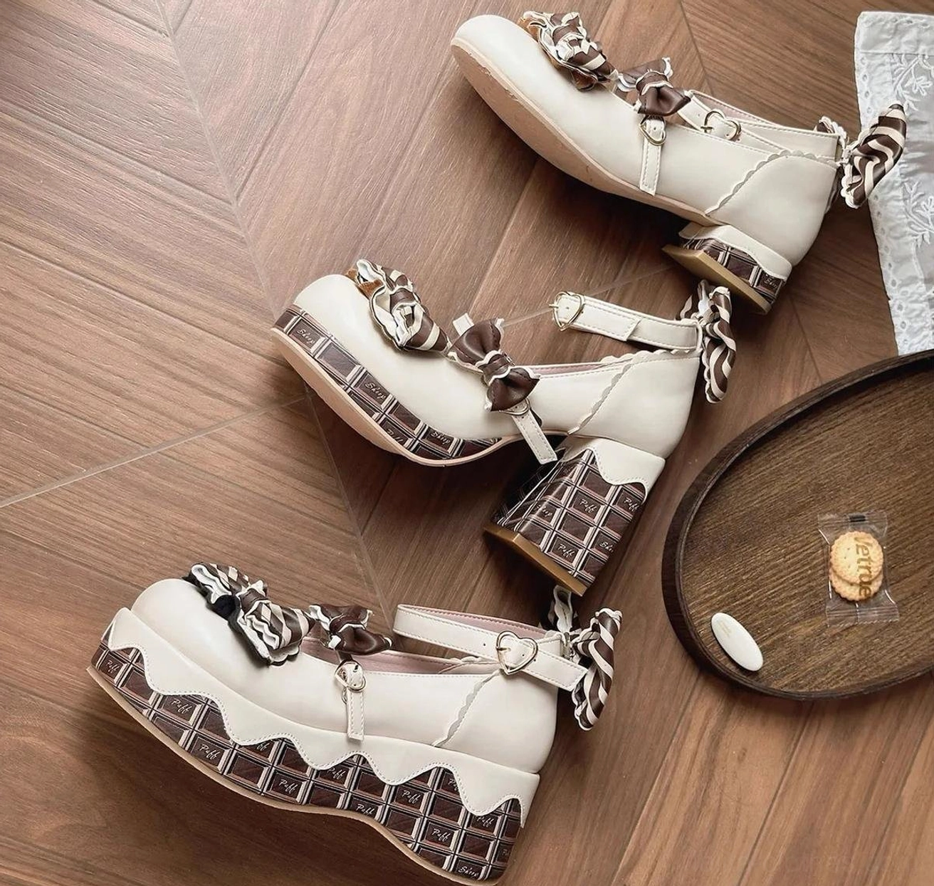 Flat lay display of off-white chocolate sweet lolita high heels with chunky checkered block heels and ankle buckle fastening straps