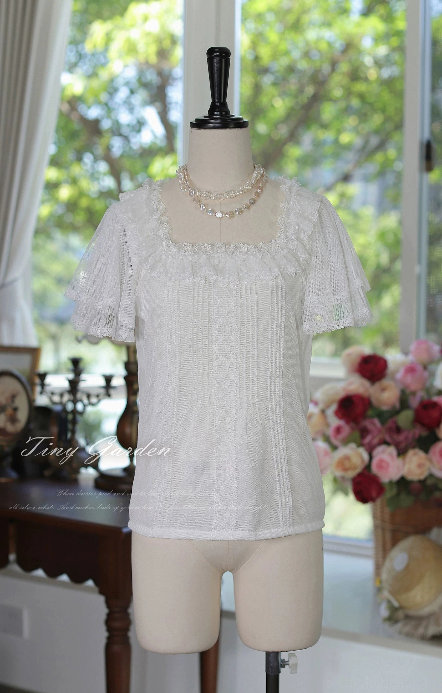 Off-white classic lolita square neck tulle blouse full-body front display shot with straight short sleeves featuring lace edge trim, pristine square neckline and decorative lace panel details against sunlit vintage backdrop