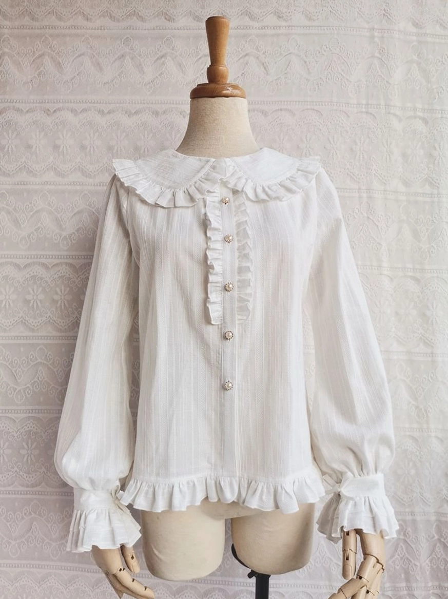 Off-white cotton Lolita blouse with Peter Pan ruffled collar front view on dress mannequin featuring ruffled placket pearl buttons and woven stripe texture