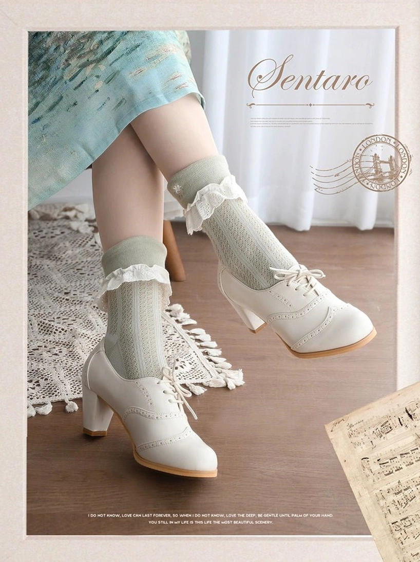 Off-white cream lolita handcrafted heel shoes with brogue perforated details and lace-up front design, paired with light blue vintage dress and light green frilly ankle socks