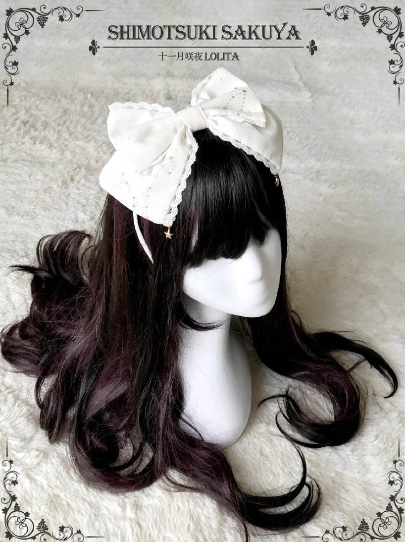 Off-white lace-edged vintage Lolita bow KC headdress with tiny star pendants displayed on mannequin with curly wig and vintage frame