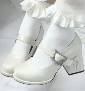 Vintage-style off-white Mary Jane lolita heel shoes with rose embossed block heel and ornate silver rose buckle, paired with frilly white sock accents, shown in top-down close-up