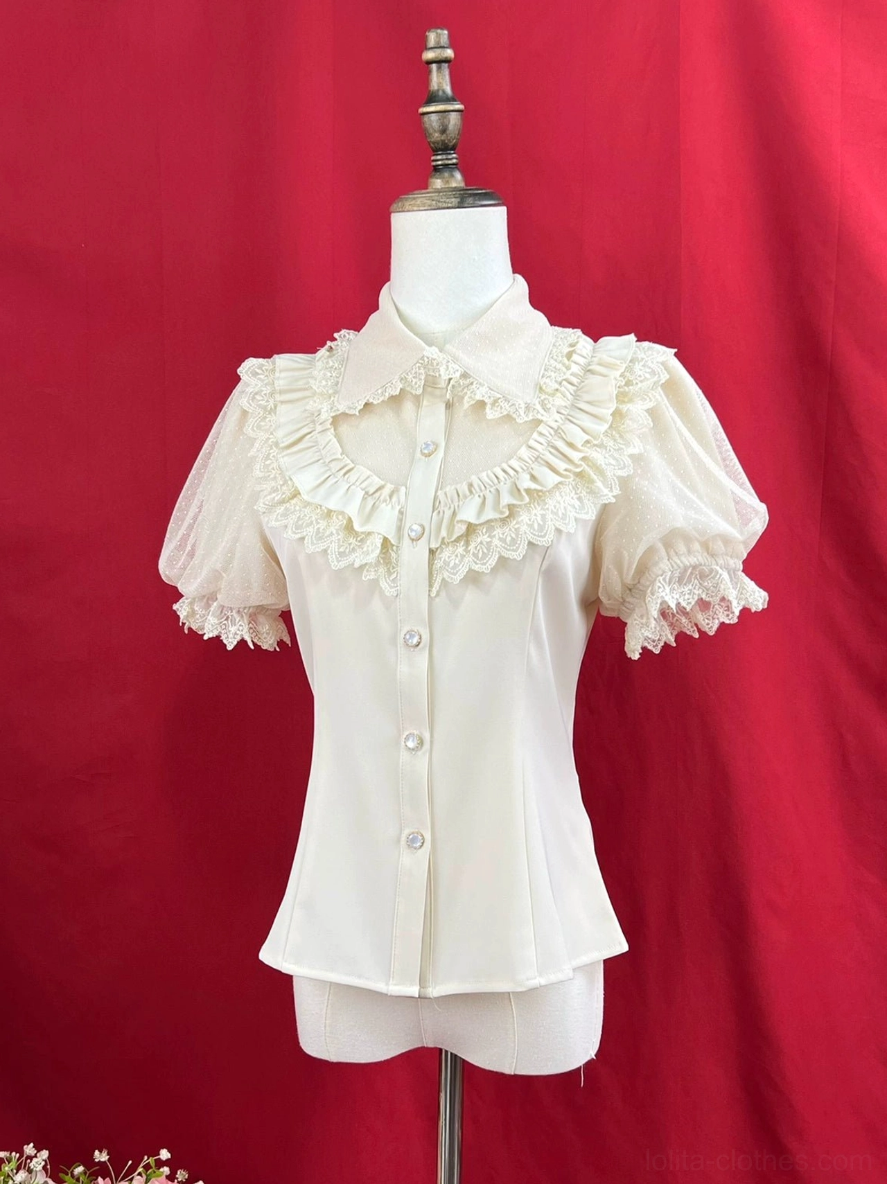 Off-white cream short-sleeve sweet lolita blouse with peter pan collar front button placket chest ruffled lace trim short puff sleeves curved hemline dress form red backdrop