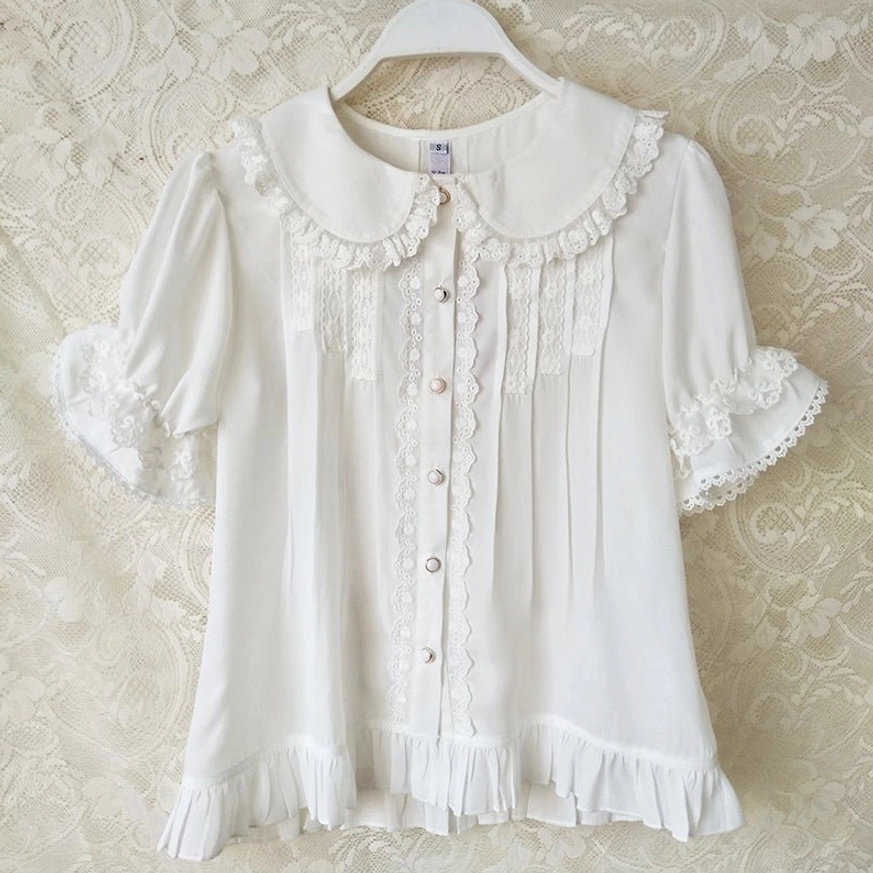 Off-white sweet lolita blouse with ruffled lace Peter Pan collar and puff sleeves front-facing on hanger showing pleated front and ruffled hem design
