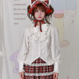 Old School Lolita floral cotton blouse with white collar bow and jabot front view - featuring off-white base with delicate scattered floral prints, puffed long sleeves with ruffled cuffs, and decorative front ruffle detail