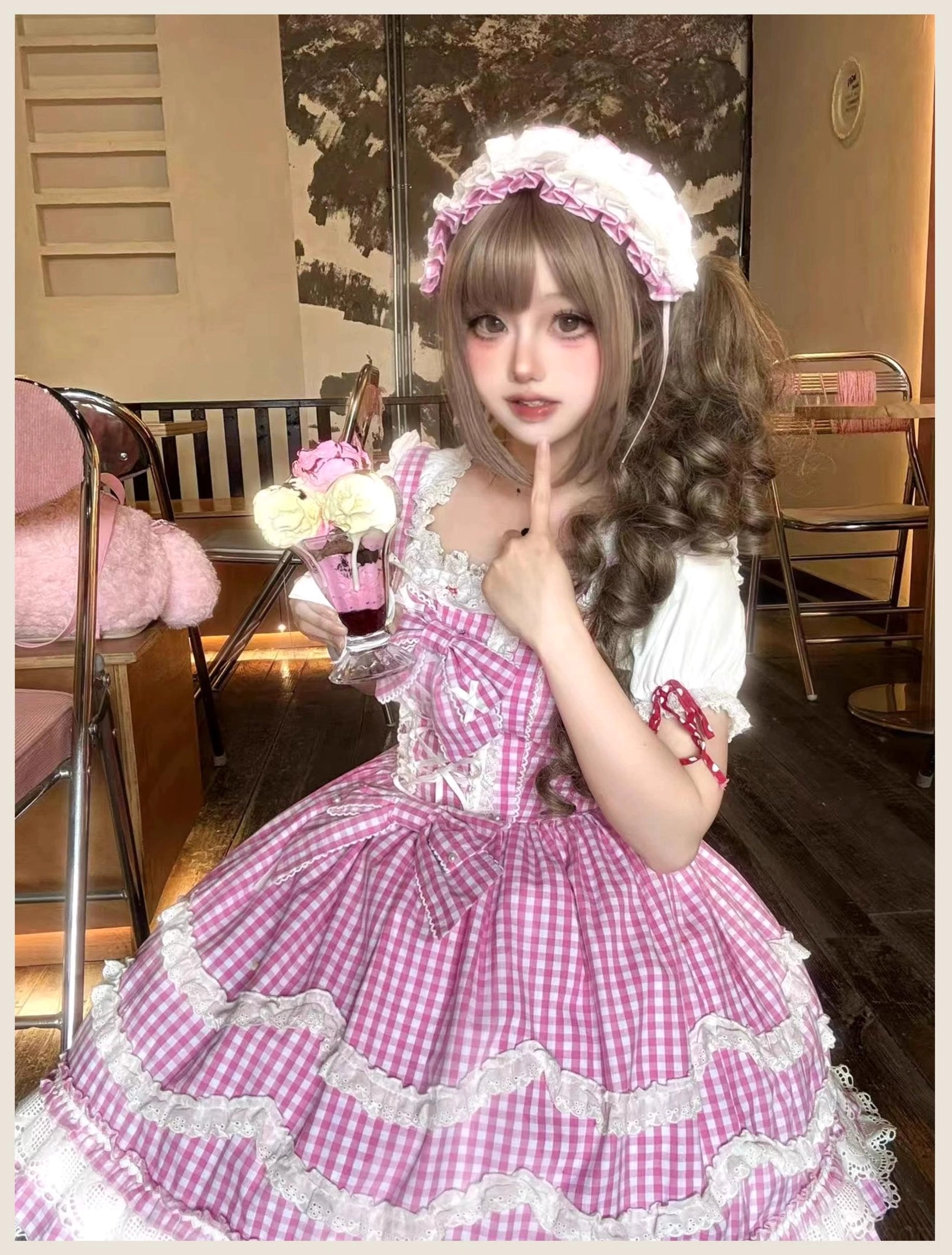 Pink gingham Lolita jumper skirt dress back view showing elastic shirred panel, adjustable lace-up design, and layered ruffle construction for vintage old school aesthetic