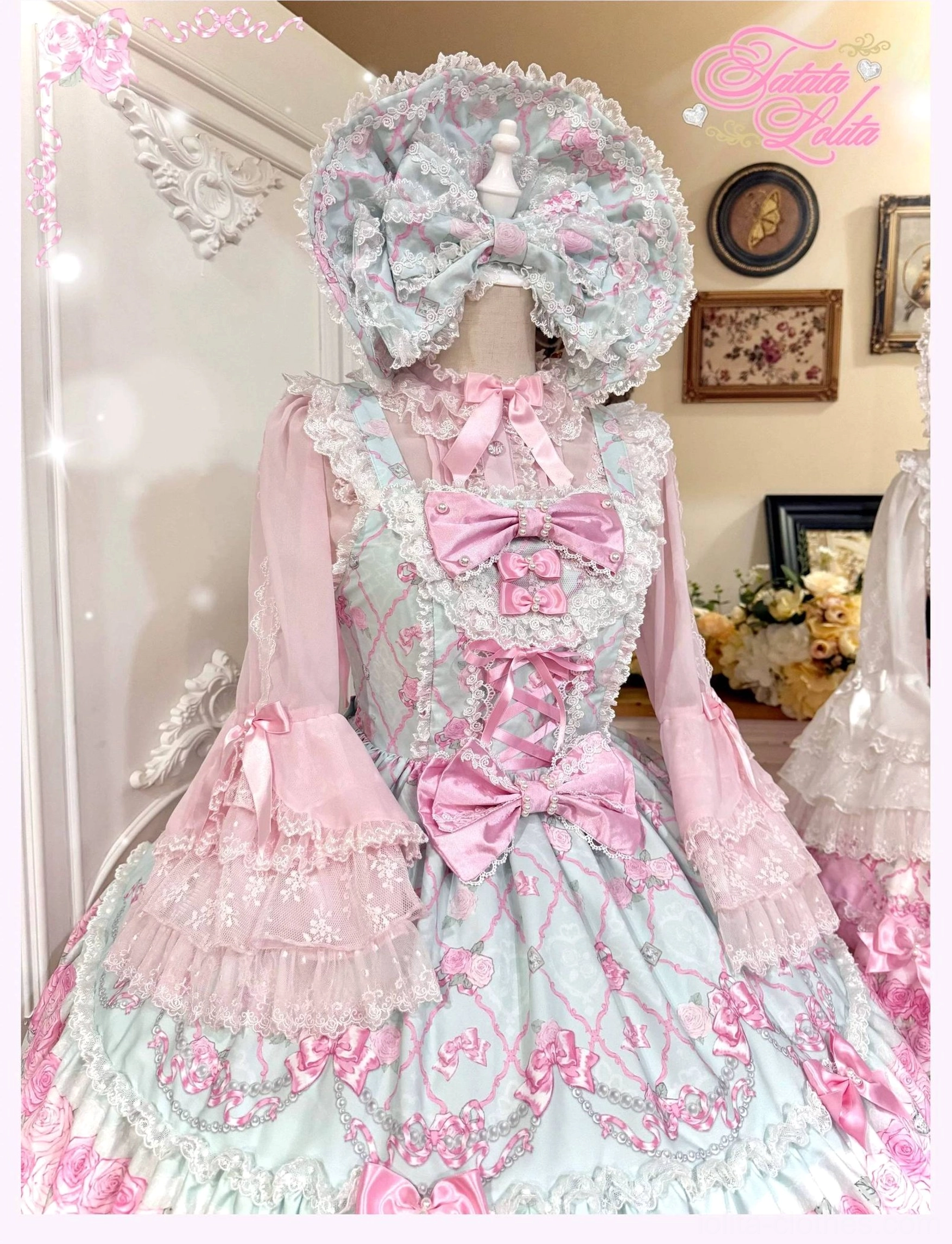 Two distinct vintage old school lolita jsk dresses displayed side-by-side on mannequins, one with short puff sleeves and one with long bishop sleeves, both featuring floral lace trims and rose print designs