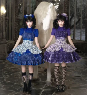 Vintage old school Lolita JSK dress with polka dot and floral print in blue and purple colorways, full-body front group view with two female models wearing matching coordinated outfits with hair accessories and layered ruffled skirts