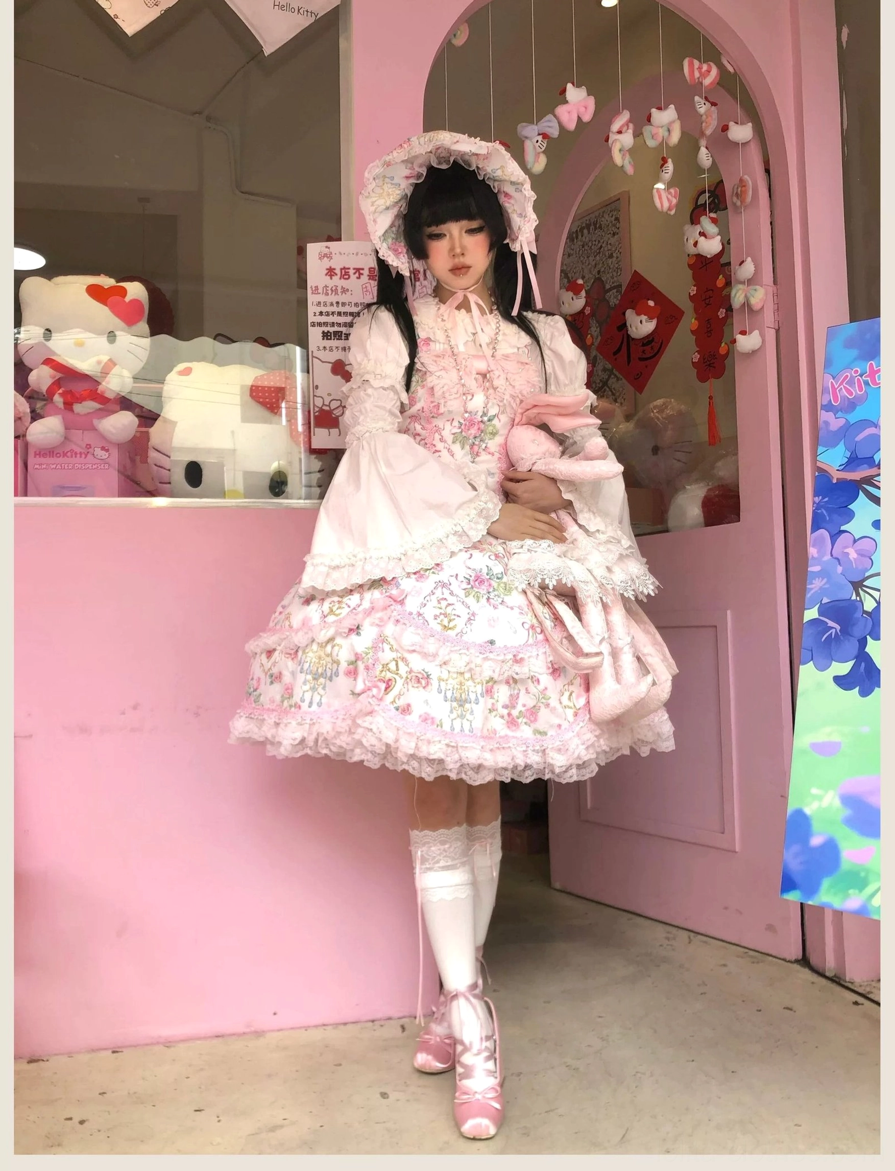 Old school Lolita JSK dress styled for themed photoshoot in garden with romantic floral print and pink accessories