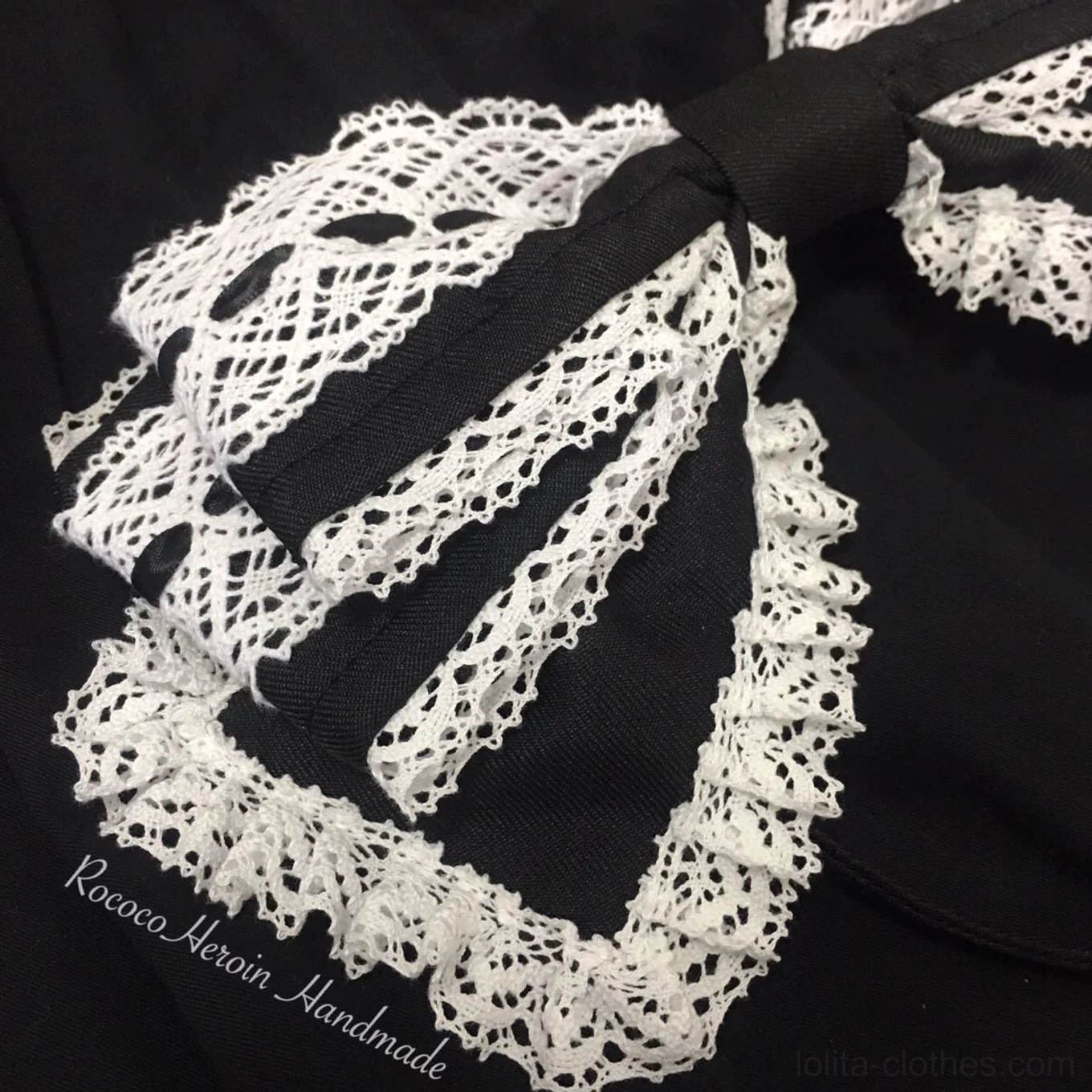 Close-up detail of black and white Old School Lolita bow KC headband with thick scalloped crochet lace and satin fabric