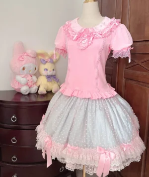 Sweet pink old school lolita blouse with peter pan collar and ruffled lace details displayed on dress form with sanrio plush toy backdrop