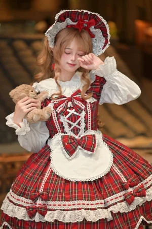 Red tartan plaid Old School Lolita complete accessory set with bunny ear headdress, bonnet and bear ear apron worn by blonde model holding teddy bear