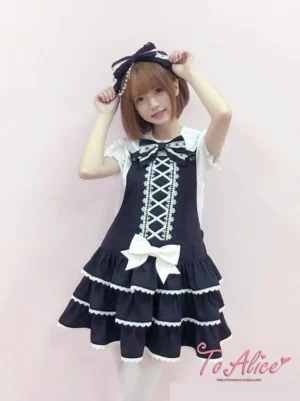 Old school lolita salopette jumper skirt dress front view with tiered ruffles white lace trim and bow pin