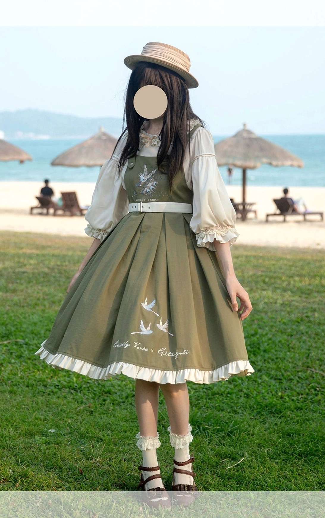 Olive green bird and branch embroidery Lolita JSK dress with inner blouse full-body side standing view coastal lawn outdoor background box pleats ruffled hem