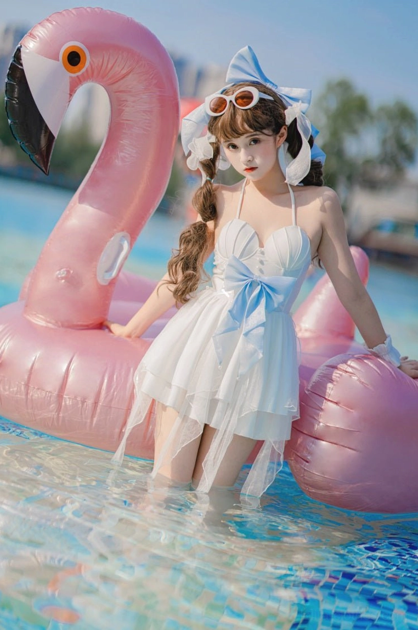 One-piece mermaid lolita dress three-quarter front standing pink flamingo float pool water halter spaghetti straps padded bust large blue bow asymmetrical skirt