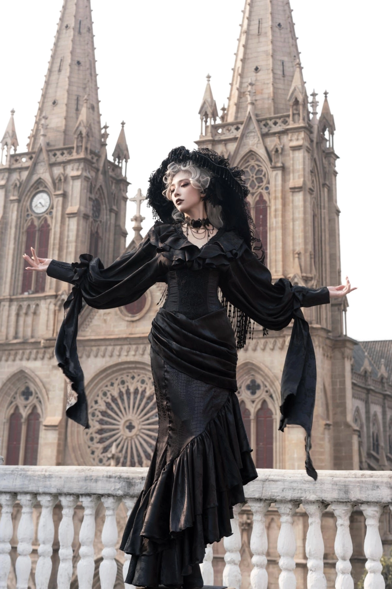 Oracle black gothic lolita mermaid skirt low-angle view with flowing sleeve sashes and structured fishtail design