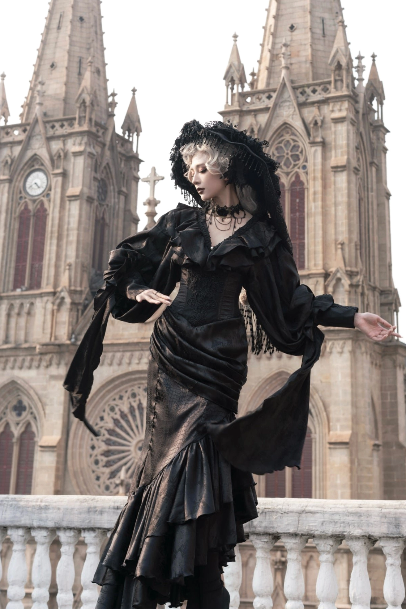 Oracle black mermaid lolita skirt side profile view showing ruched waist and flowing decorative sleeve scarves outdoors