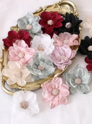 Elegant vintage organza flower lolita hairpin collection in multiple colors displayed on vintage gold tray