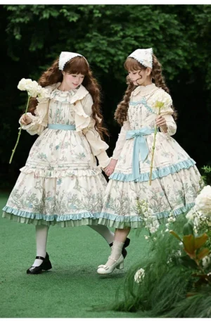 Country Lolita Oriole Time OP dress with long bishop sleeves and ruffled cuffs worn by models walking through lush green garden foliage, showcasing side silhouette and coordinating maid hairband