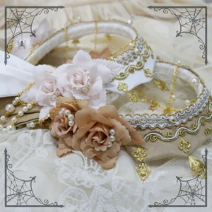 ornate lolita headdress accessories flat lay top down view with beige white base gold silver embroidery roses pearl gold chain charms on lace background