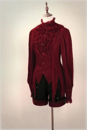 Burgundy red gothic Ouji blouse with high ruffled collar, lace-trimmed placket and lace cuffs, paired with black shorts, display mannequin styling