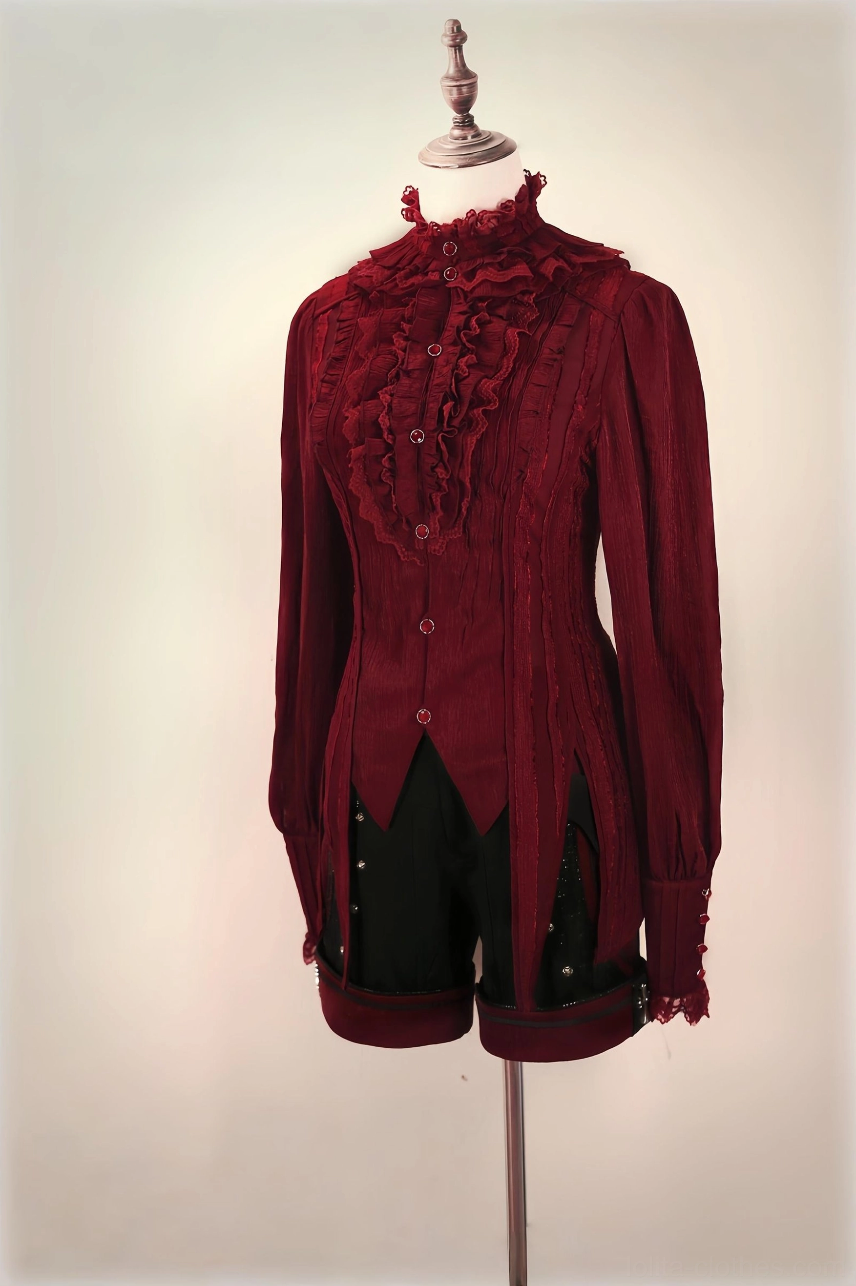 Burgundy red gothic Ouji blouse with high ruffled collar, lace-trimmed placket and lace cuffs, paired with black shorts, display mannequin styling