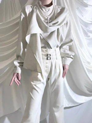Front full-body view of ouji cowl neck asymmetric draped shirt and high-waisted wide-leg pants in cream off-white, featuring double-buckle waist belt and long relaxed sleeves on faceless male model