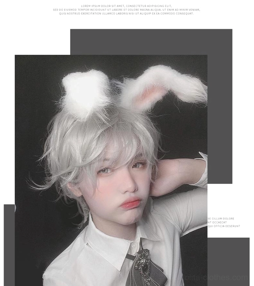Frontal view of gray slightly curly wig with ornate grey bow cravat brooch on model in white collared shirt
