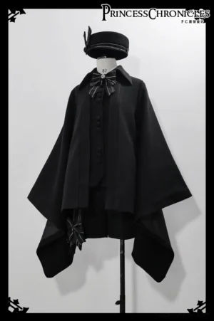 Studio display of black ouji lolita winter cape coat on dress form, showing asymmetrical hemline, front button placket, detachable striped bow tie, wool beret accessory, thick winter woolen fabric construction
