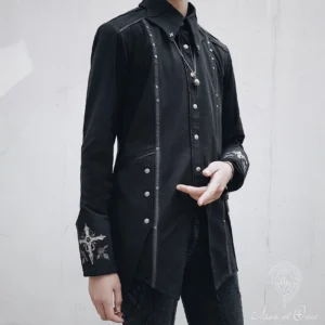 Ouji lolita long-sleeve black gothic shirt front three-quarter view on androgynous male model, featuring pointed collar, silver studs, cross and rose embroidery on cuffs, and asymmetric hem design