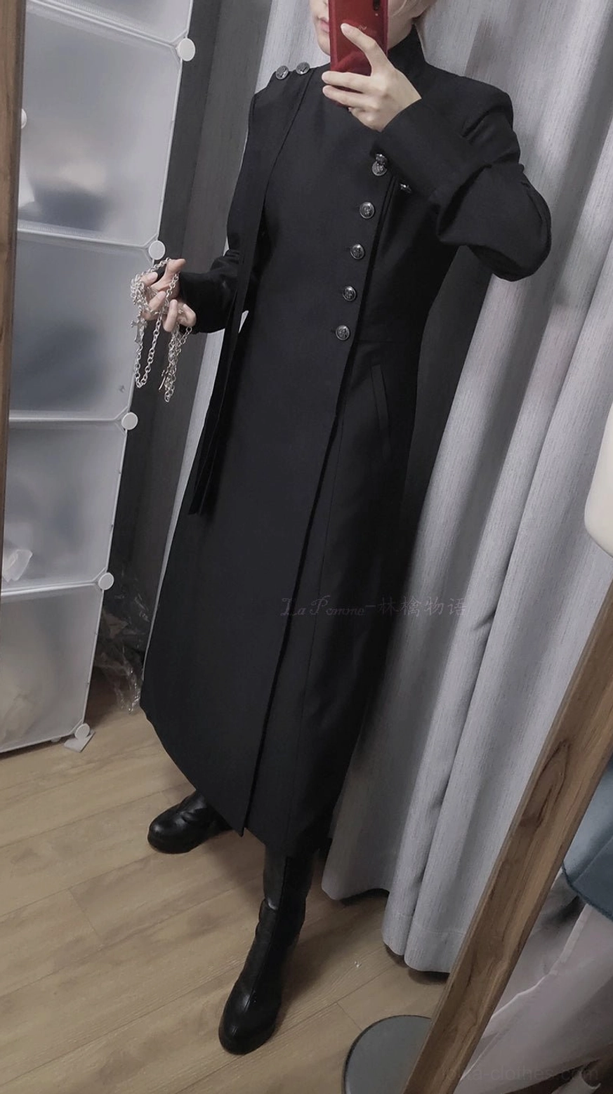 Black slim long Ouji coat worn by male model, left side-front mirror selfie, metal chain accessory and black leather boots, side silhouette view