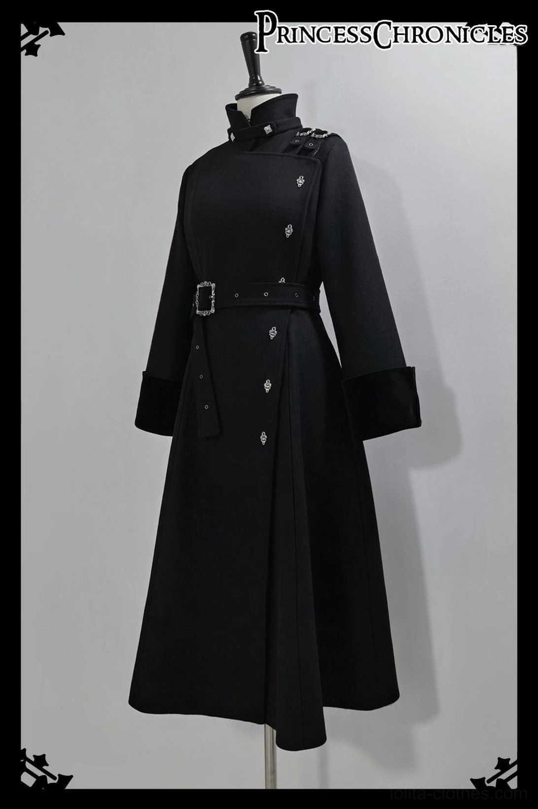 Front full view of black Ouji Lolita overcoat on dress mannequin displaying stand collar long sleeves with velvet trim waist belt metal studs elegant A-line long cut silhouette