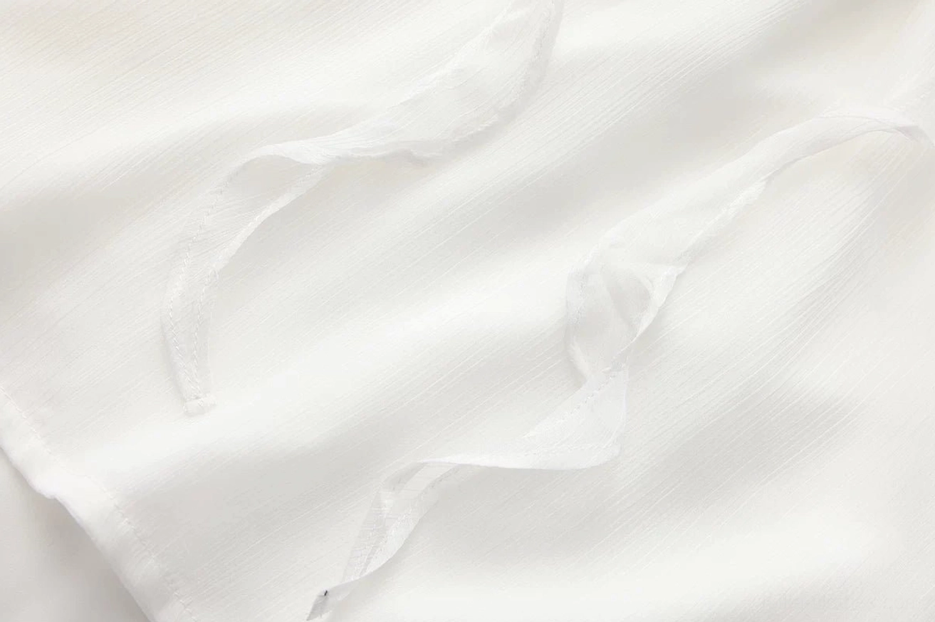 Sheer layered ruffles detail of ouji lolita chiffon blouse showing multiple cascading ruffled tiers and delicate chiffon fabric texture, macro close-up of ruffle construction