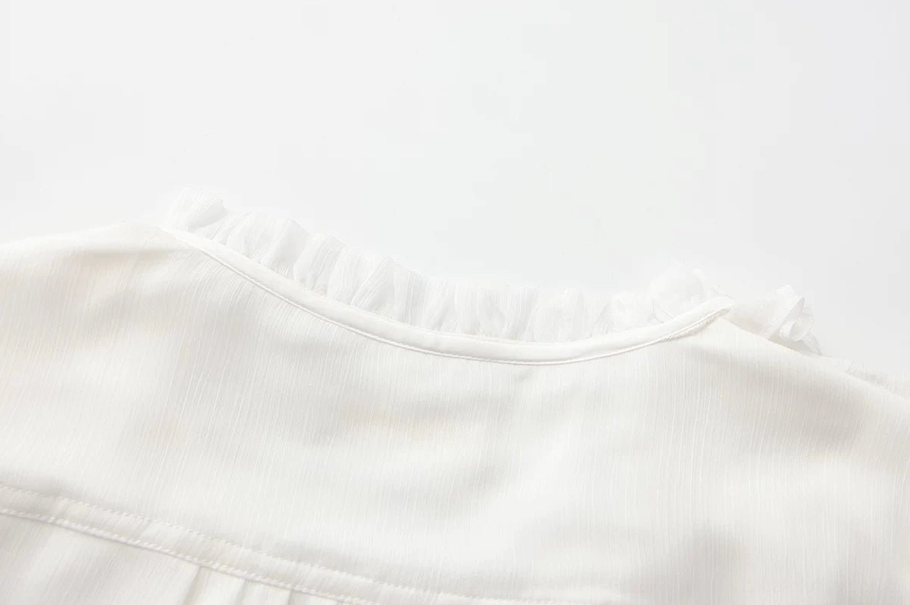 Vintage gold decorative button and metal hardware close-up detail of ouji lolita blouse lace-up front placket, showing antique-style embellishment and construction quality