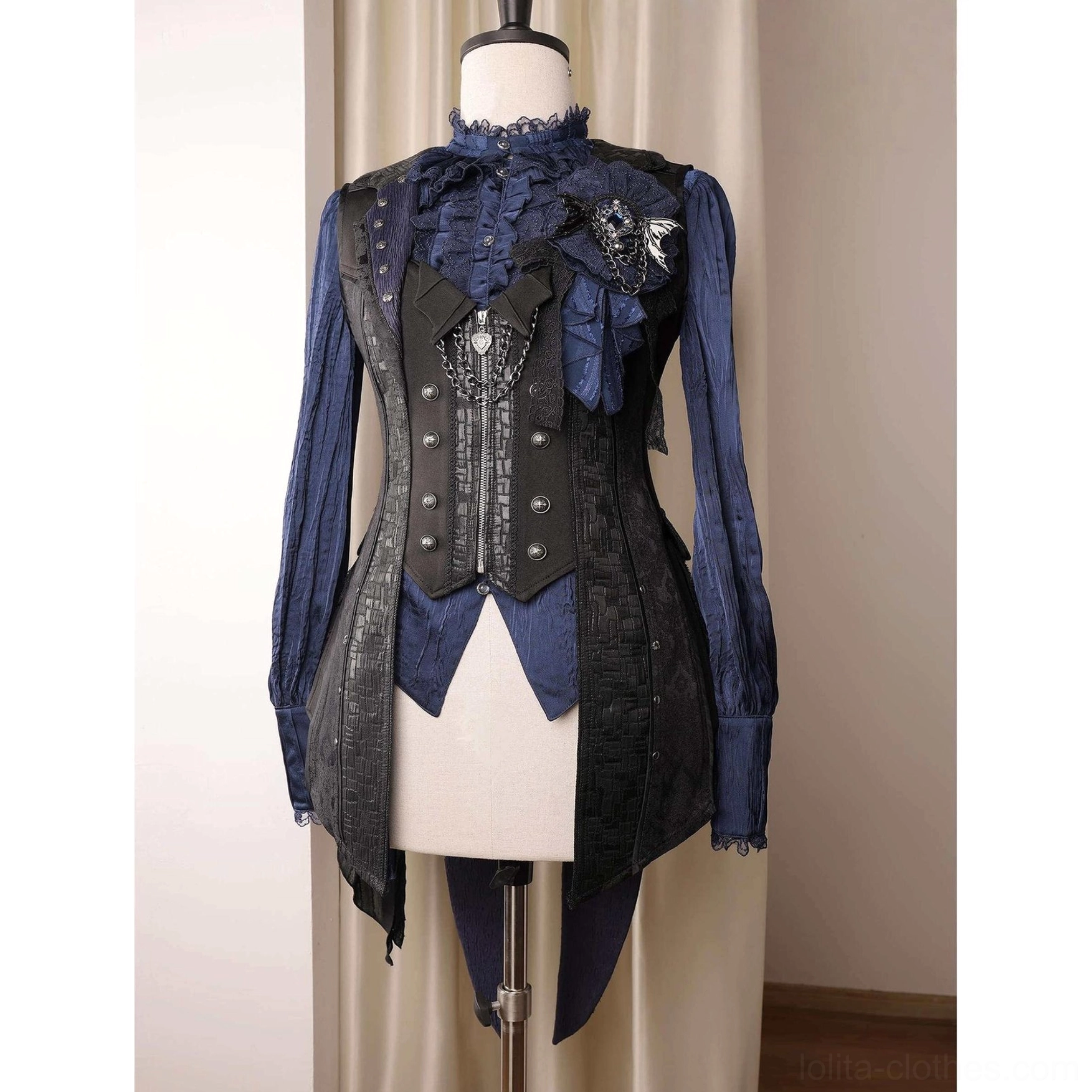 Navy blue Ouji lolita blouse layered with black decorative vest, hanamaru brooch and high ruffled collar, asymmetrical tail hem styling
